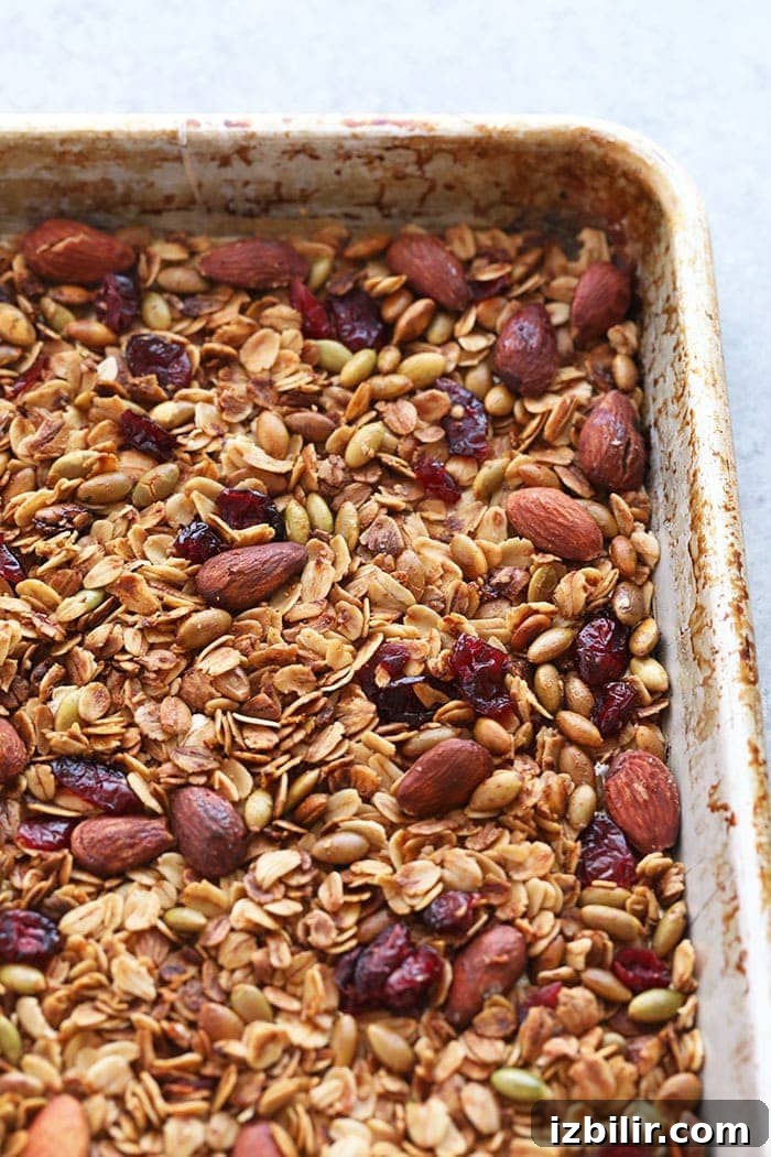 Crunchy homemade granola ready to bake Granola on a baking sheet