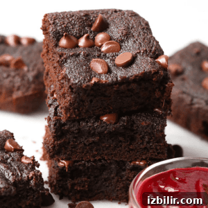 Fudgy Chocolate Beet Brownies 2 a stack of chocolate beet brownies with raspberry sauce.