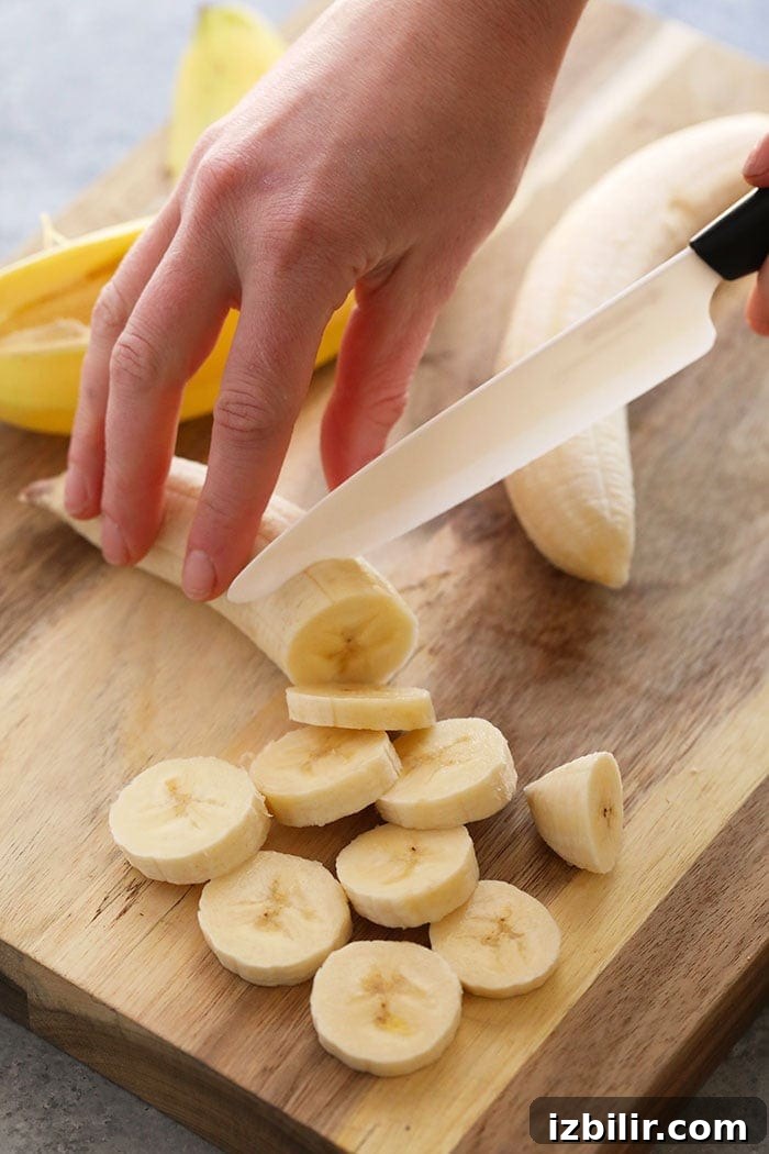 Slicing bananas on a cutting board Slicing bananas on a cutting board