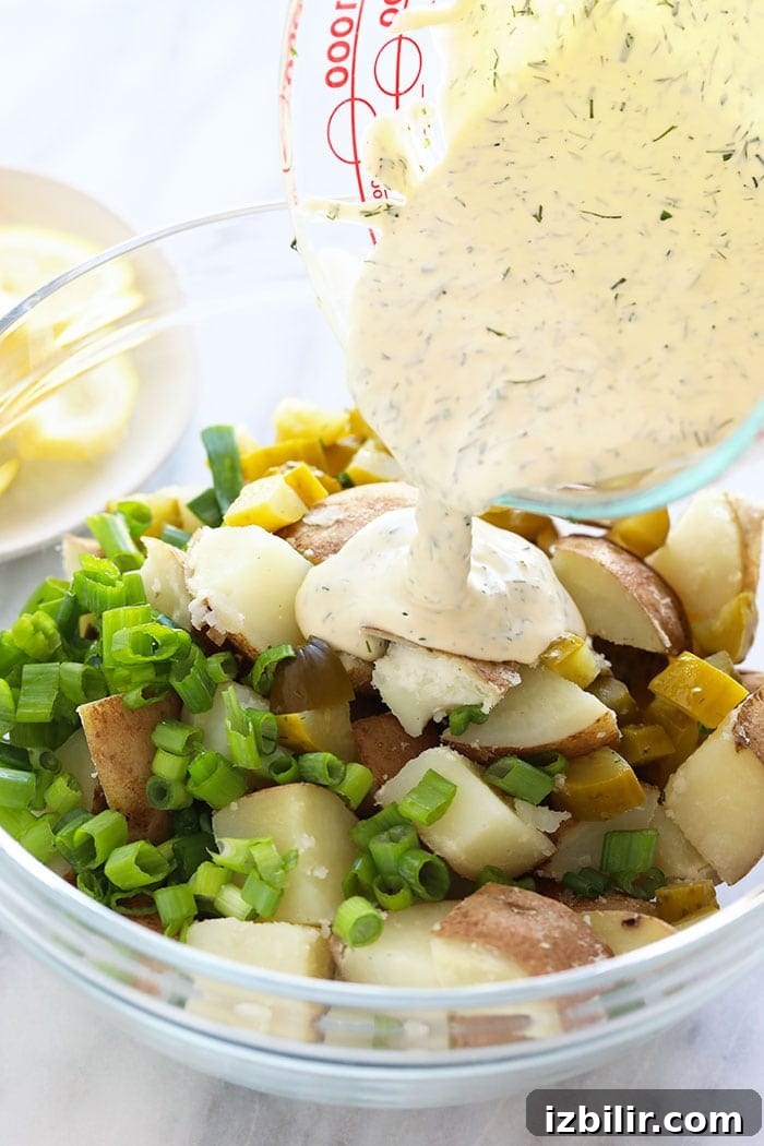 This vegan potato salad is light, bright, and delicious! Not only is this potato salad the perfect summer side, but it's also so easy to make. Pouring sauce over vegan potato salad ingredients