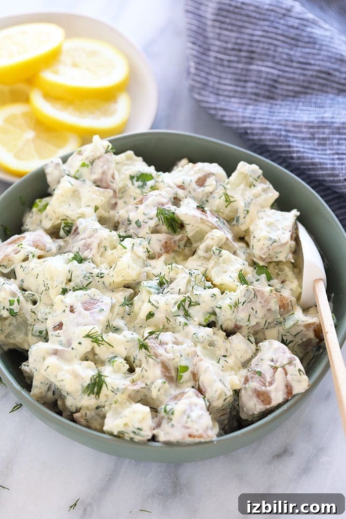 This vegan potato salad is light, bright, and delicious! Not only is this potato salad the perfect summer side, but it's also so easy to make. A bowl of vegan potato salad ready to be served