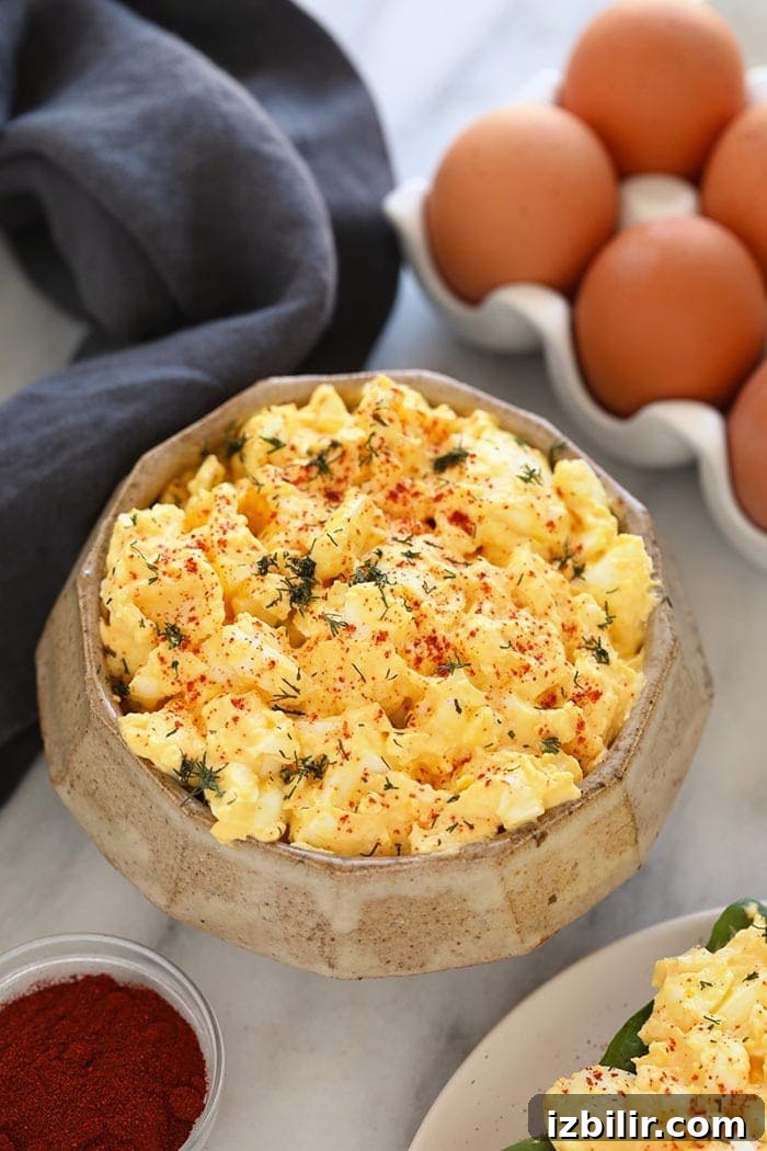 Healthy egg salad in a bowl topped with dill.