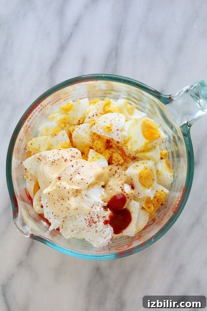 Healthy egg salad ingredients in a bowl.