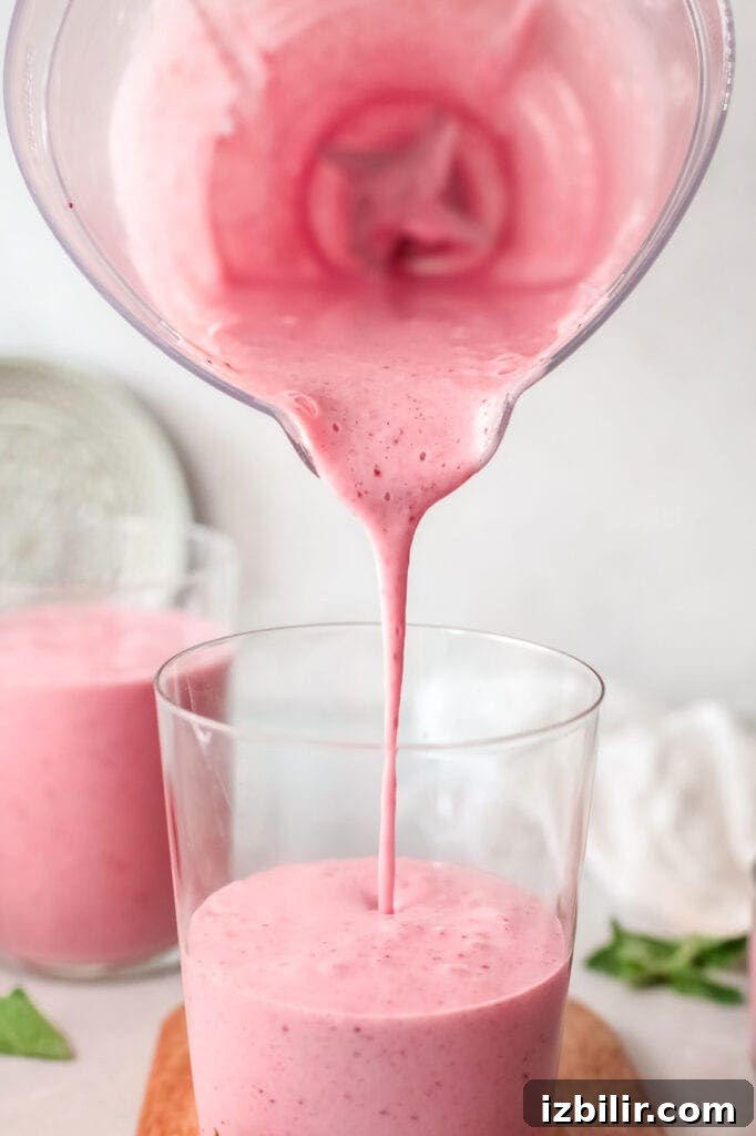 Pouring smoothie into a glass pouring smoothie into glass