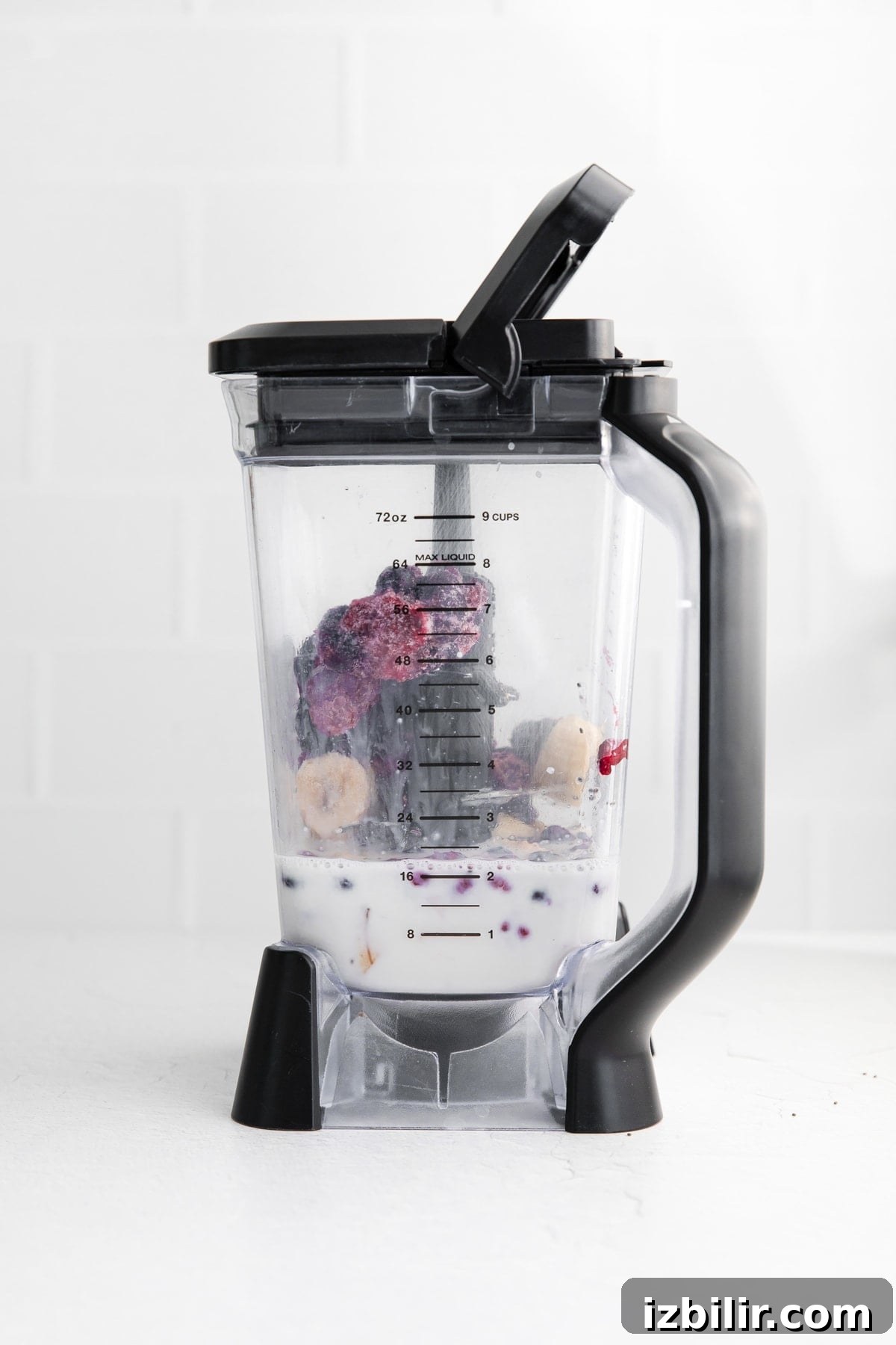 Triple Berry Smoothie in Blender triple berry smoothie ingredients in a blender.