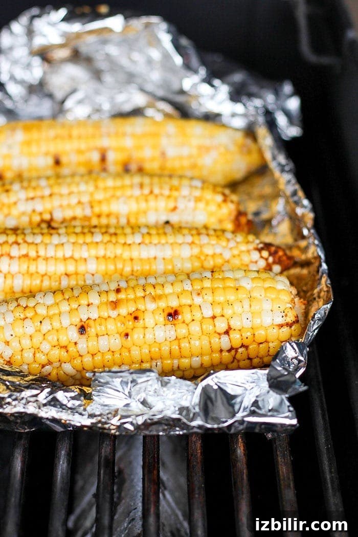 corn in tin foil on grill.