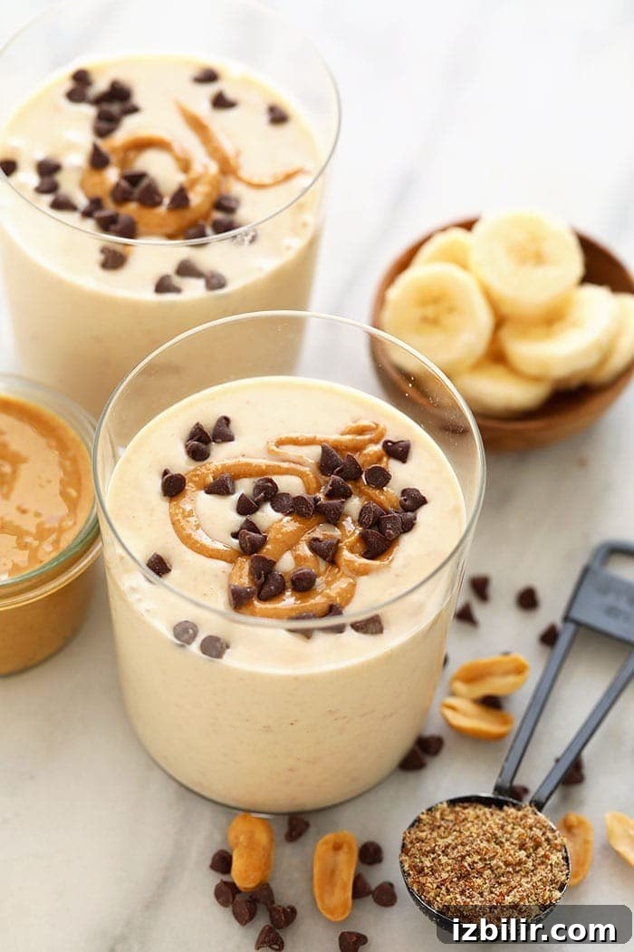This peanut butter banana smoothie truly tastes like a decadent milkshake, but is actually made with whole fruit, milk, and peanut butter! peanut butter banana smoothie in glass.