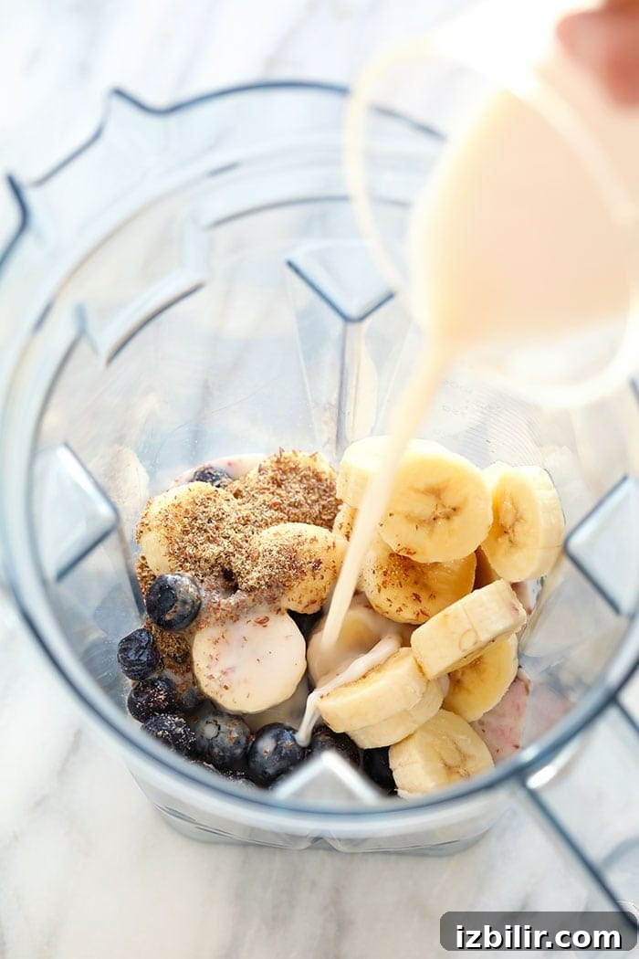 Pouring almond milk into a blender