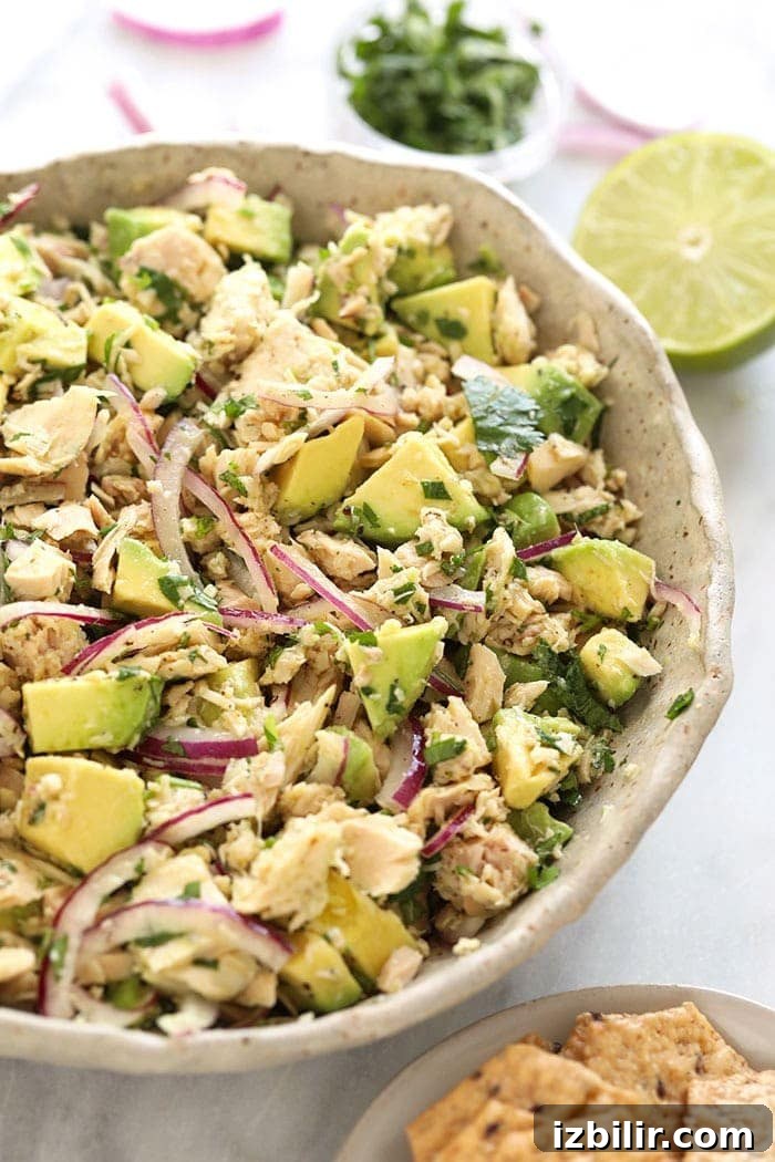 avocado tuna salad in a bowl next to crackers.