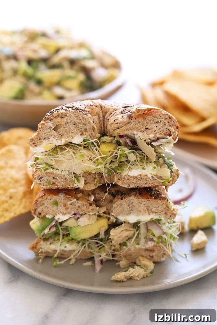 Creamy Avocado Tuna Salad Sandwich Recipe 4 avocado tuna salad sandwich on a bagel on a plate