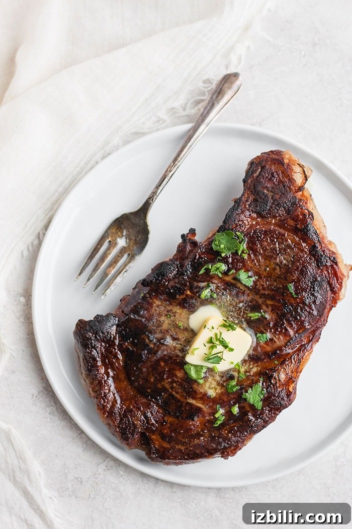 Sous vide steak with butter and fresh parsley on top.