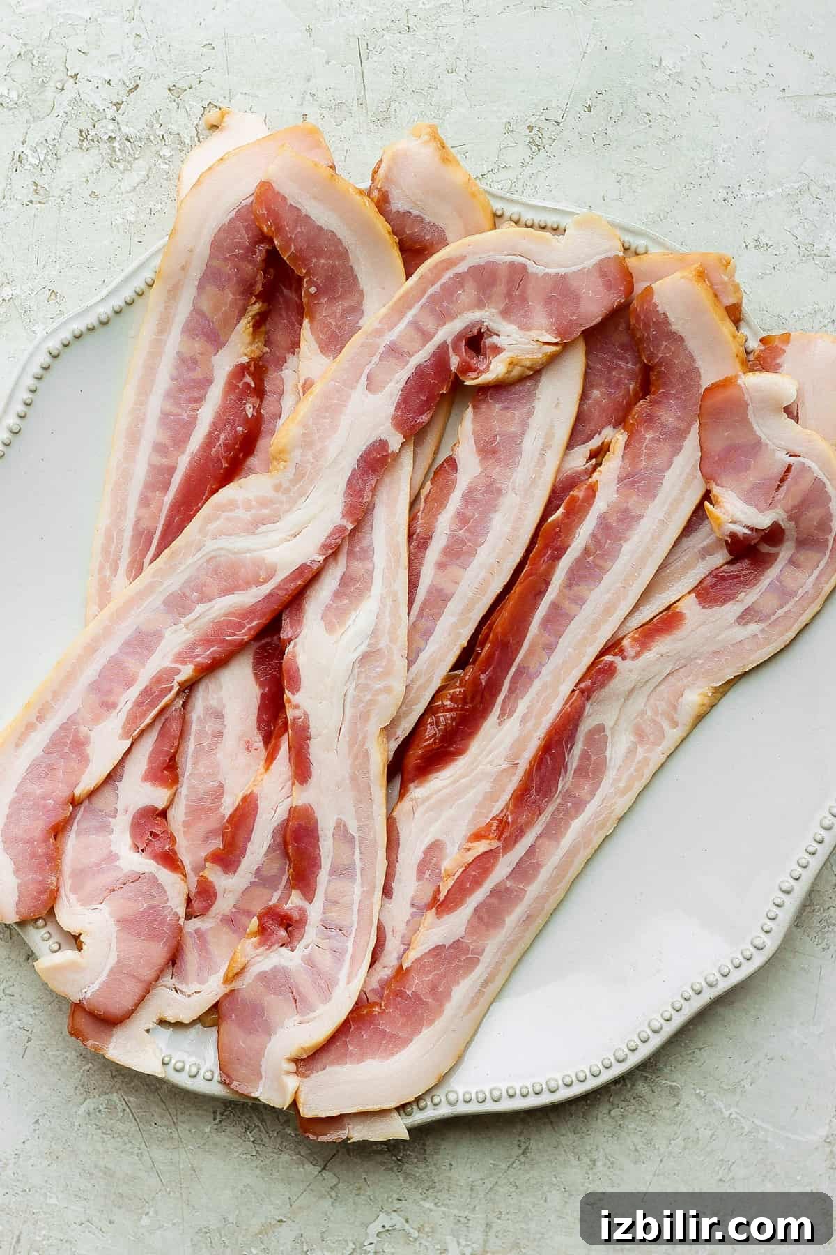 sliced bacon on a white plate.