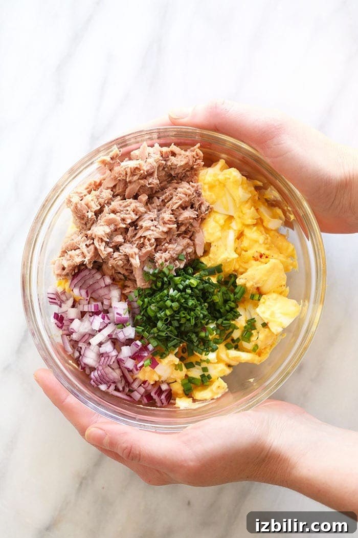This Tuna Egg Salad blends the flavors you love from tuna salad with egg salad for a satisfying and protein-packed lunch! tuna egg salad ingredients in a bowl