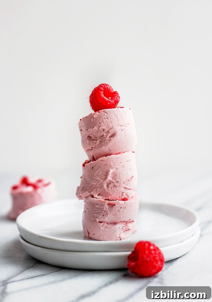 Keto Raspberry Cheesecake Fat Bombs 2 Fat bombs stacked with raspberry on top