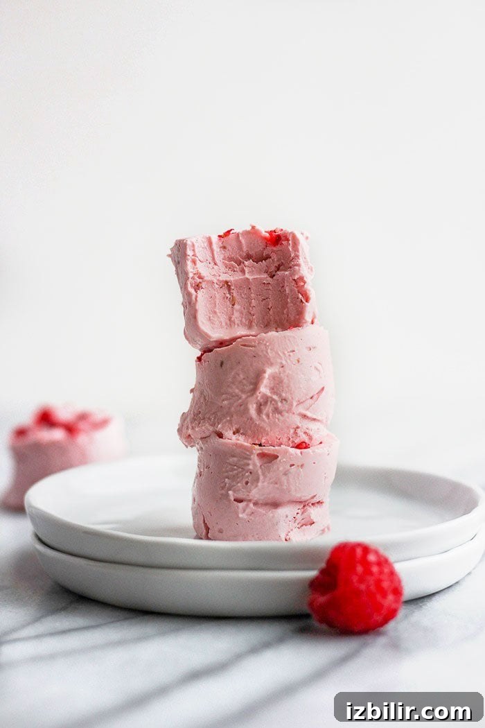 Keto Raspberry Cheesecake Fat Bombs 6 cheesecake fat bombs stacked with bite taken out of it