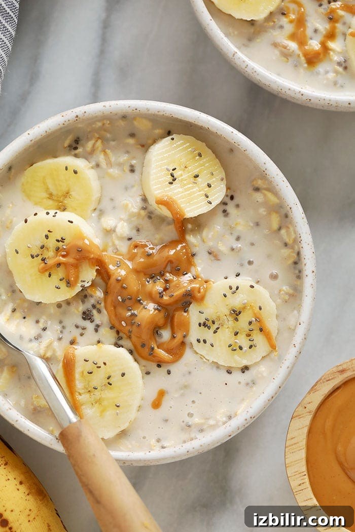 creamy banana overnight oats in a bowl topped with sliced bananas and chia seeds