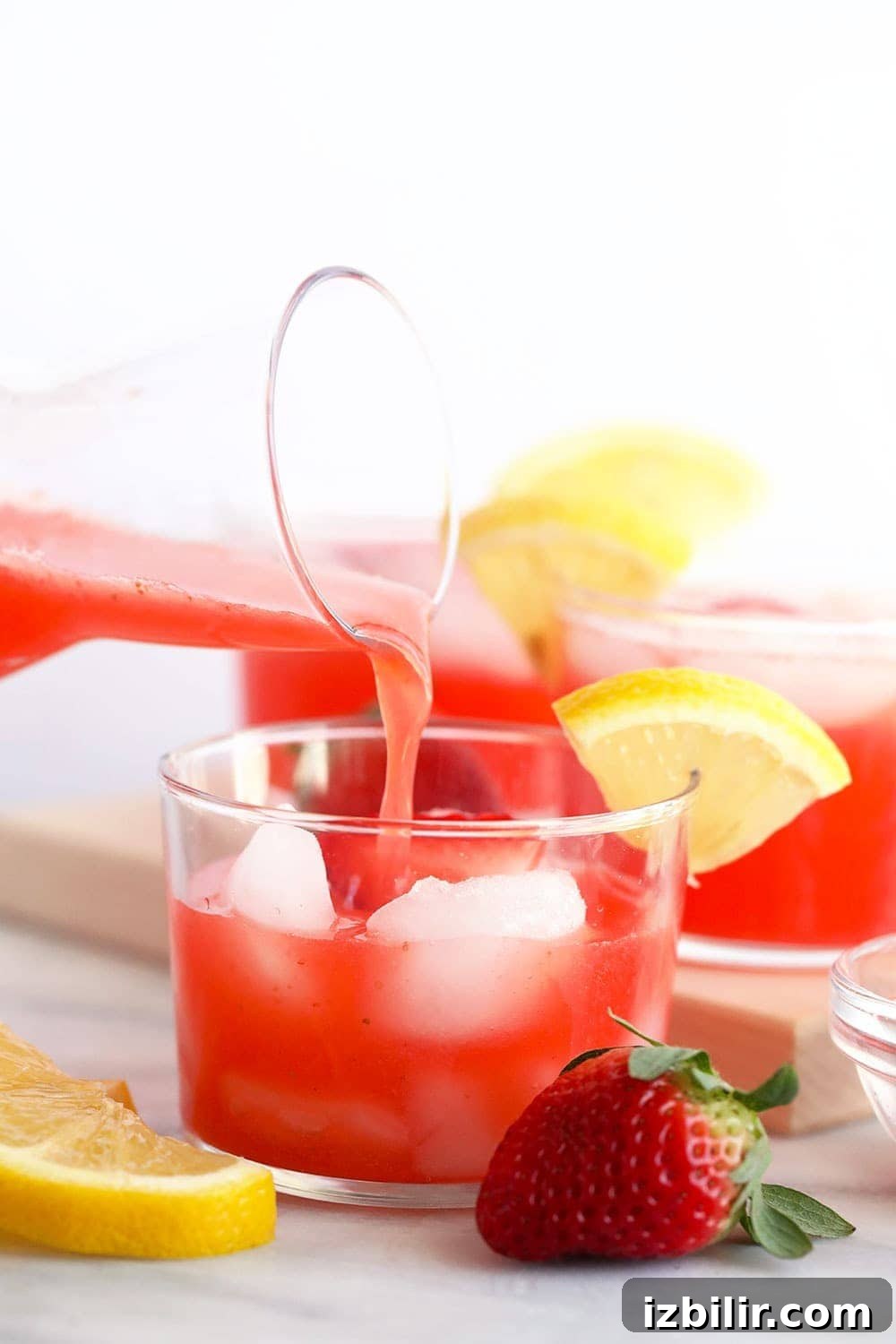15+ Vodka Cocktail Recipes You Need to Try Tonight 14 a glass of spiked strawberry lemonade being poured.