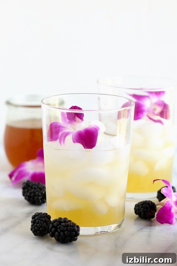 Pouring hibiscus tea into glass arnold palmer drink in a glass before pouring hibiscus tea over the top