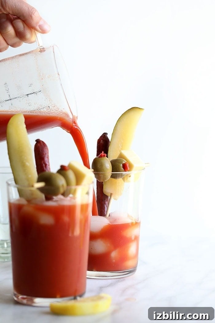 Pouring Bloody Mary Mix into a glass