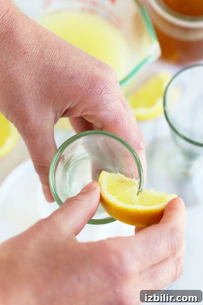 Rimming the glass with sugar putting lemon juice on a martini glass rim