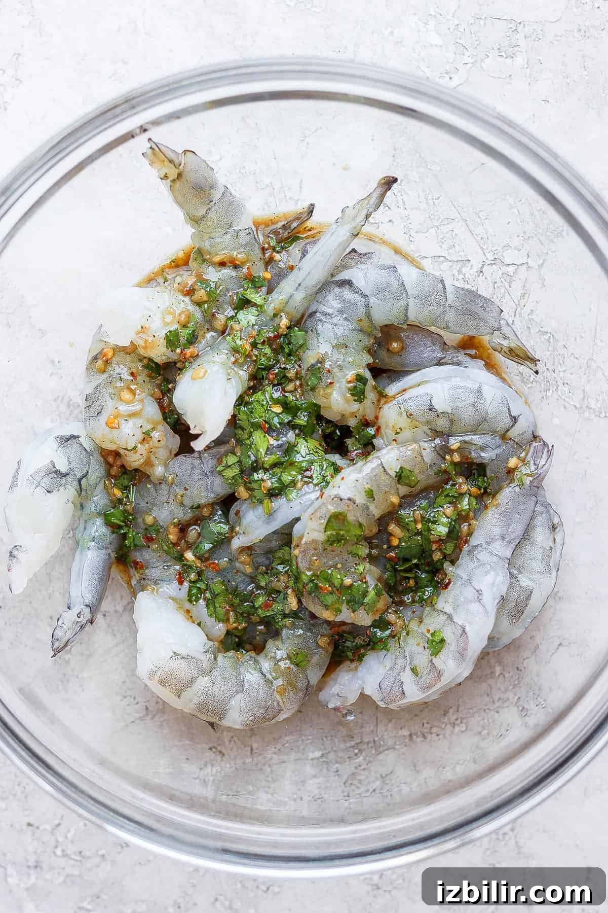 raw shrimp marinating in bowl.