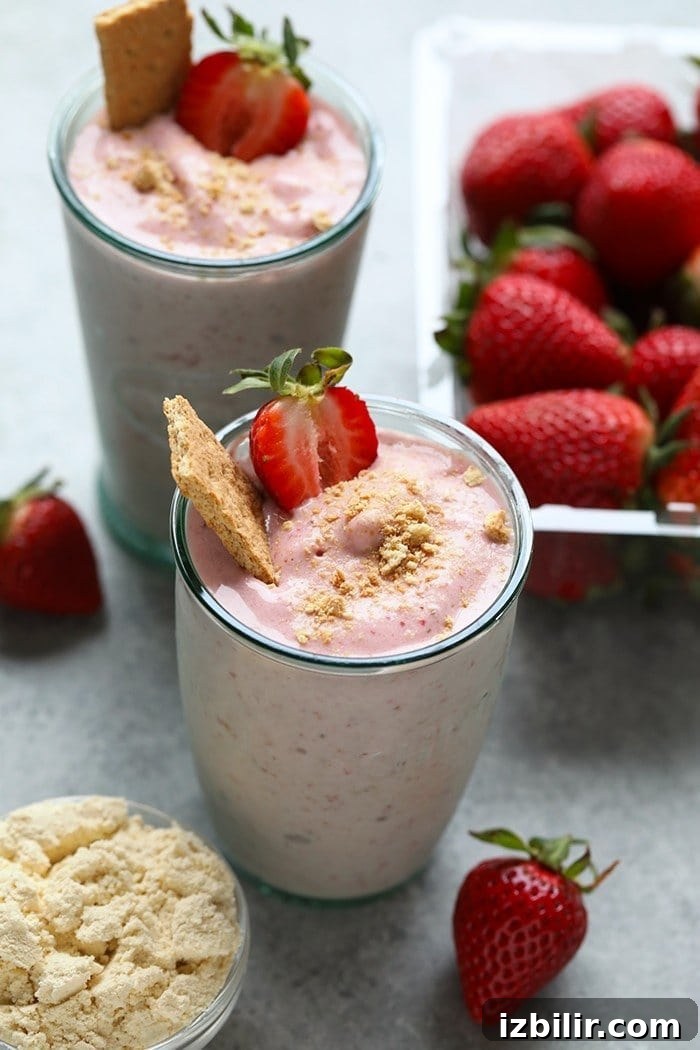 Strawberry Protein Shake Recipe for Post-Workout Recovery 2 Strawberry cheesecake protein smoothie in a glass