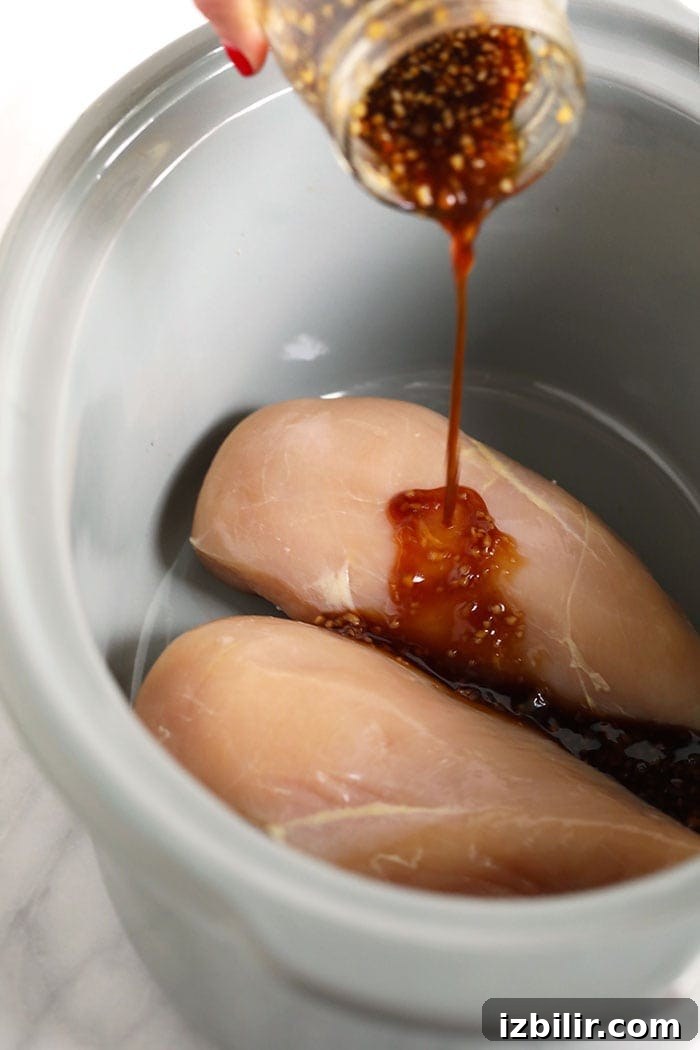 teriyaki sauce pouring onto chicken