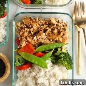 a crock pot dish with teriyaki chicken served over rice, broccoli, and carrots.