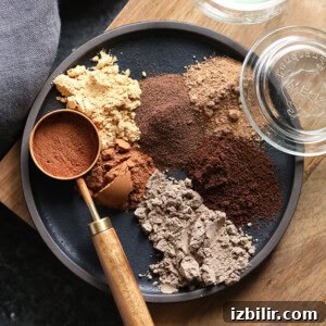 Authentic Homemade Chai Masala Spice Blend 3 a black plate with various ingredients including chai spices on it.