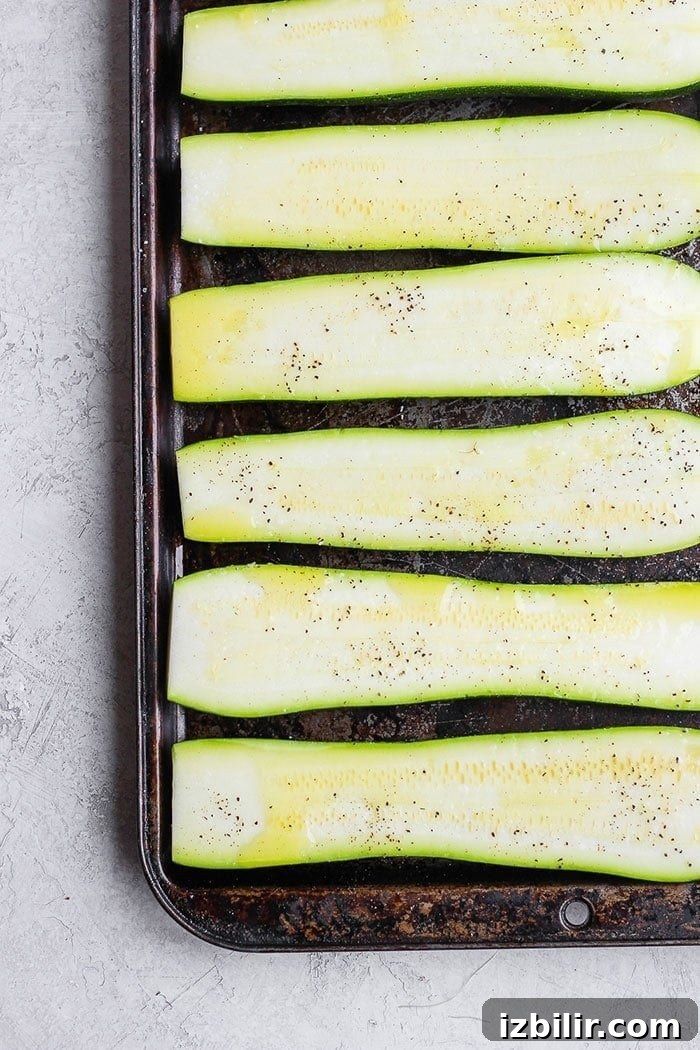 Turn on the grill and throw on some zucchini! Making grilled zucchini is easy and if you do it right you'll end up with grilled zucchini with a little crunch rather than a soggy mess. Grab the zucchini from your garden or the grocery store and get grilling! fresh zucchini on a baking sheet drizzled in oil.