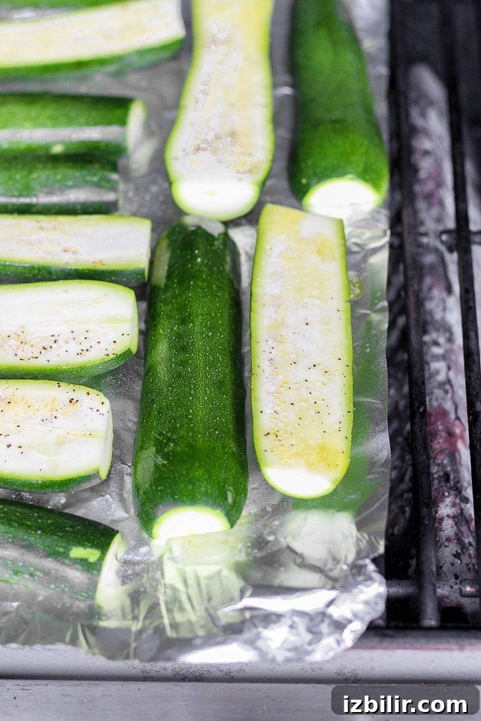 Turn on the grill and throw on some zucchini! Making grilled zucchini is easy and if you do it right you'll end up with grilled zucchini with a little crunch rather than a soggy mess. Grab the zucchini from your garden or the grocery store and get grilling! zucchini being grilled.