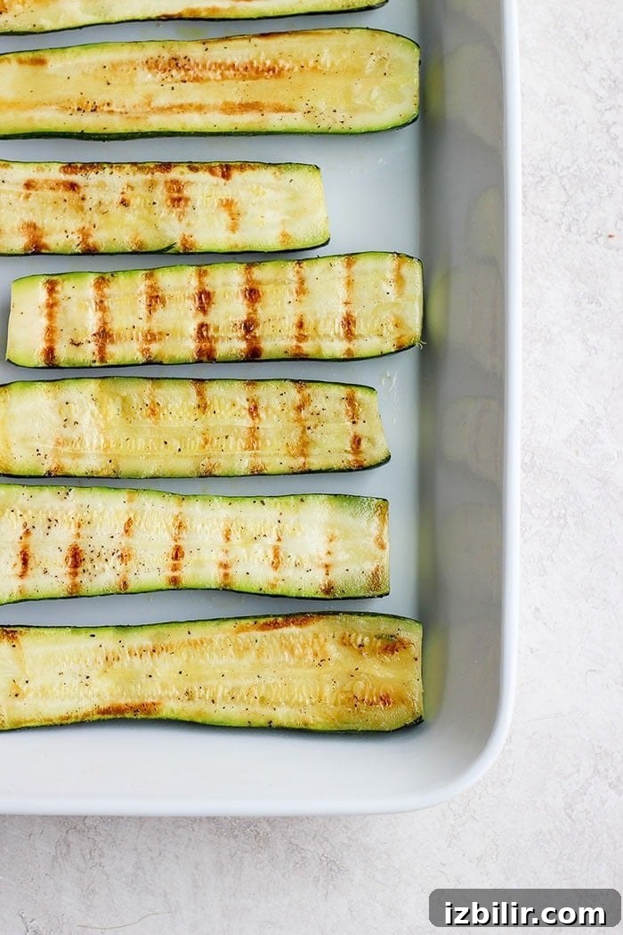 Turn on the grill and throw on some zucchini! Making grilled zucchini is easy and if you do it right you'll end up with grilled zucchini with a little crunch rather than a soggy mess. Grab the zucchini from your garden or the grocery store and get grilling! grilled zucchini in a baking dish.