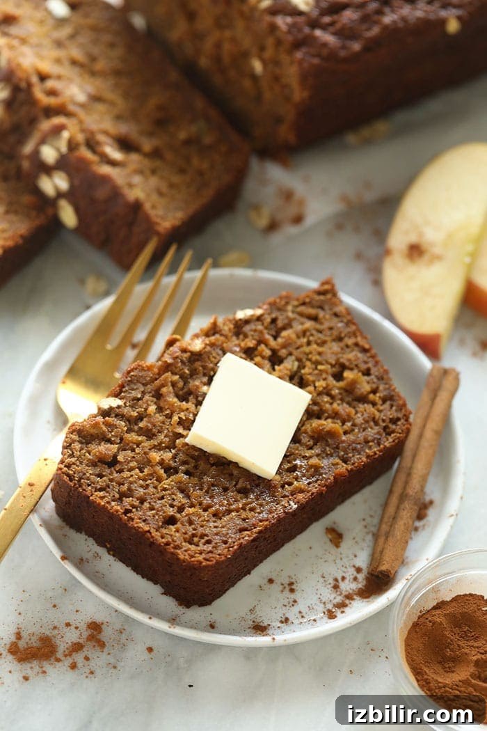Homemade Apple Cinnamon Bread Recipe 6 Slice of cinnamon apple bread on a plate with a pad of butter.
