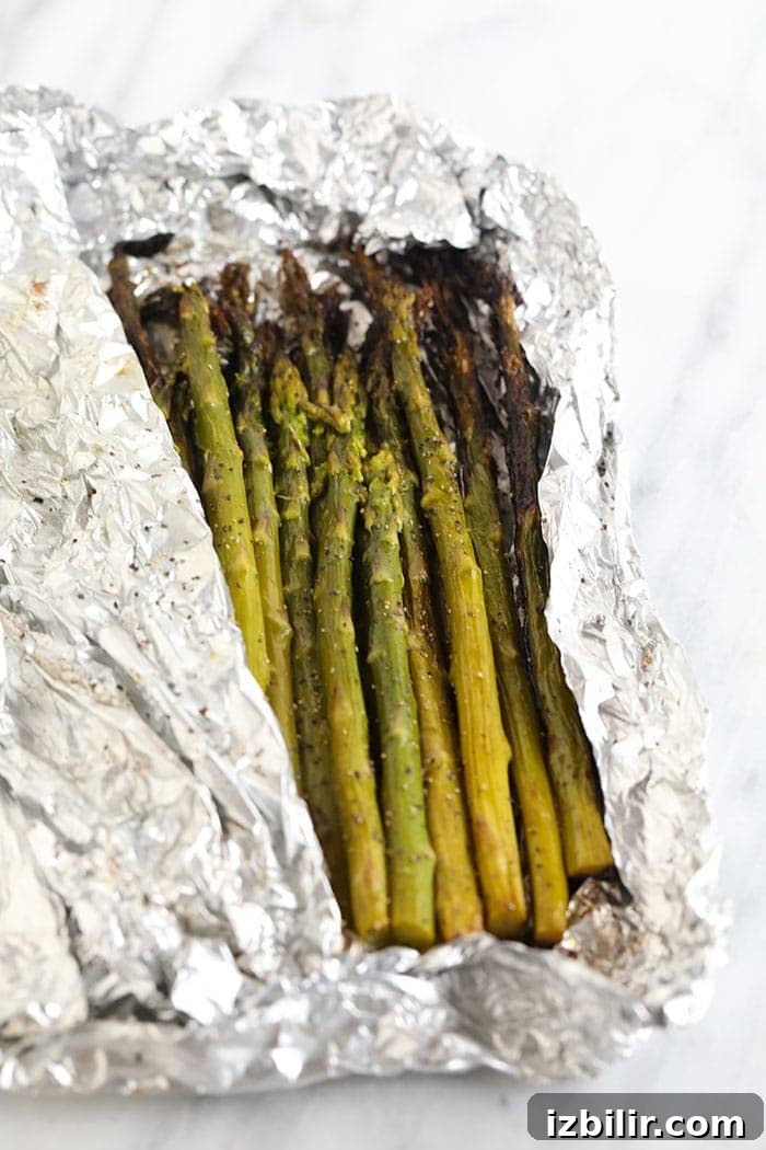 perfectly grilled asparagus in an opened foil packet