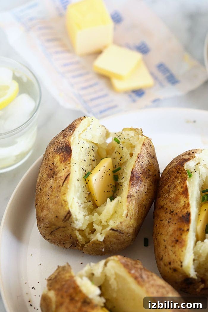 Baked potato in foil with butter baked potato in foil with butter