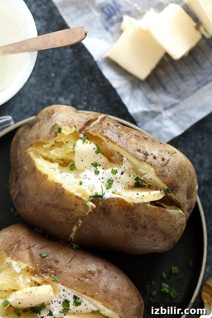 crock pot baked potatoes topped with chives and sour cream