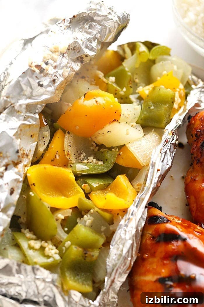 Peppers and onions are an easy thing to throw together for any summer meal! It compliments any piece of meat, burgers, etc. Our basic recipe only calls for 5 ingredients and a foil pack. Foil pack grilled peppers and onions