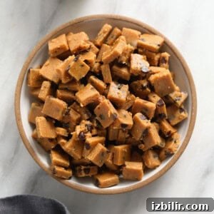 Peanut butter fudge with cookie dough bites in a bowl.