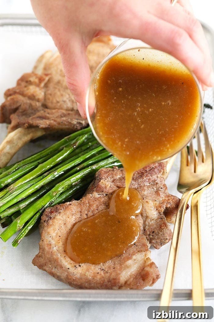 Pouring whiskey gravy over pork chops pouring gravy on pork chops