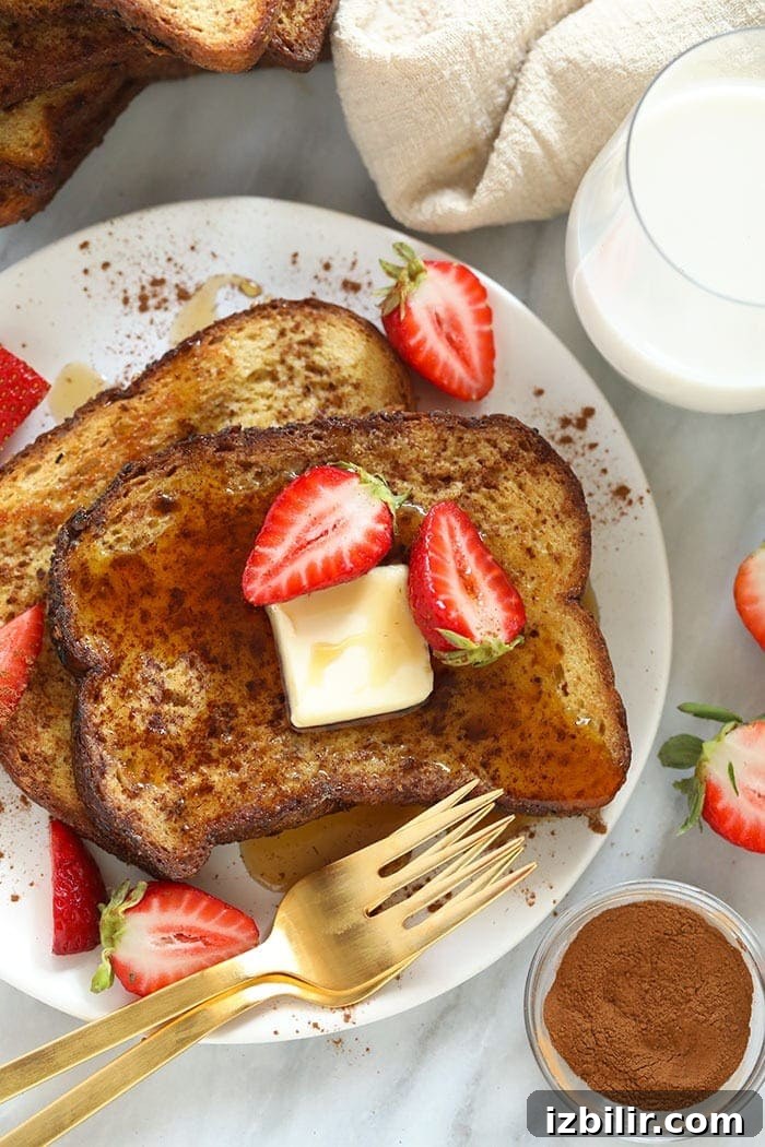 sheet pan french toast on a plate with strawberries