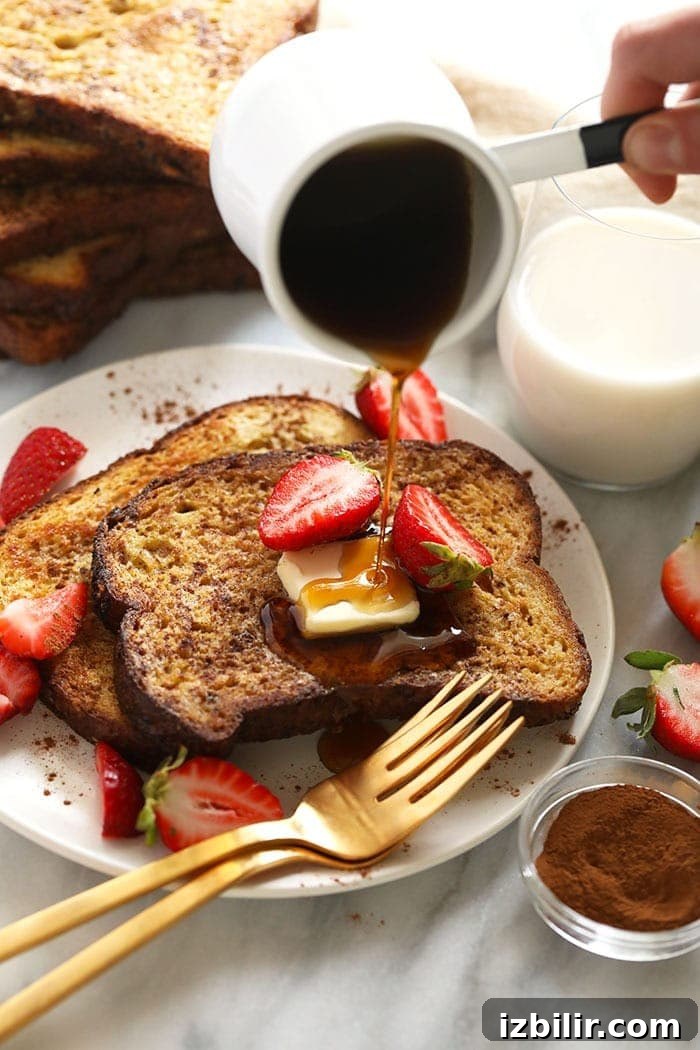 sheet pan french toast on a plate drizzled with maple syrup