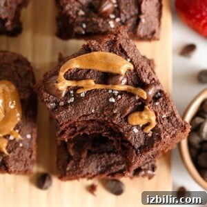 Paleo peanut butter chocolate brownies on a cutting board.