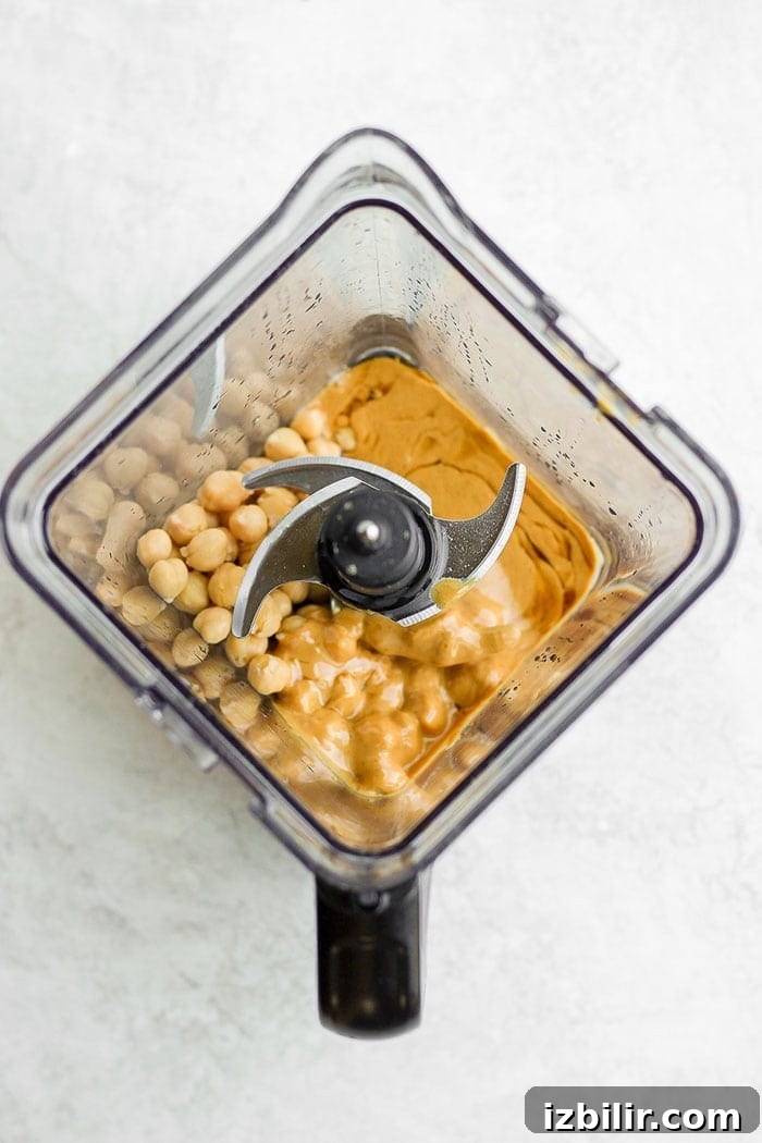 This funfetti cake batter dip is a sweet treat that is not only delicious but healthy! It's made with garbanzo beans, maple syrup, cashew butter, and vanilla. It tastes exactly like cake batter! Ingredients in a blender