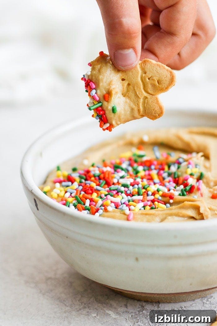 This funfetti cake batter dip is a sweet treat that is not only delicious but healthy! It's made with garbanzo beans, maple syrup, cashew butter, and vanilla. It tastes exactly like cake batter! Cake batter dip with an animal cracker