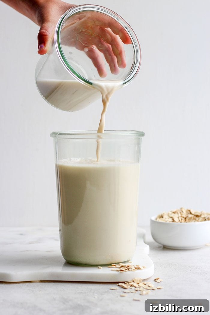 Pouring oat milk into a glass