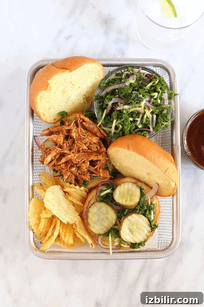 Slow cooker BBQ pulled chicken served with chips and slaw. slow cooker bbq pulled chicken in basket with chips and slaw