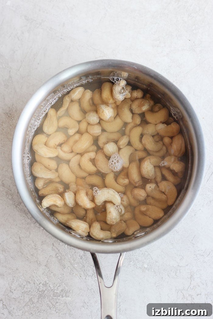 Flash boiling cashews before blending cashews in a sauce pan ready to be flash boiled