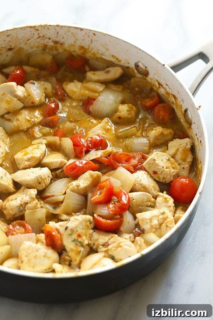 Pesto chicken pasta in a skillet pan.