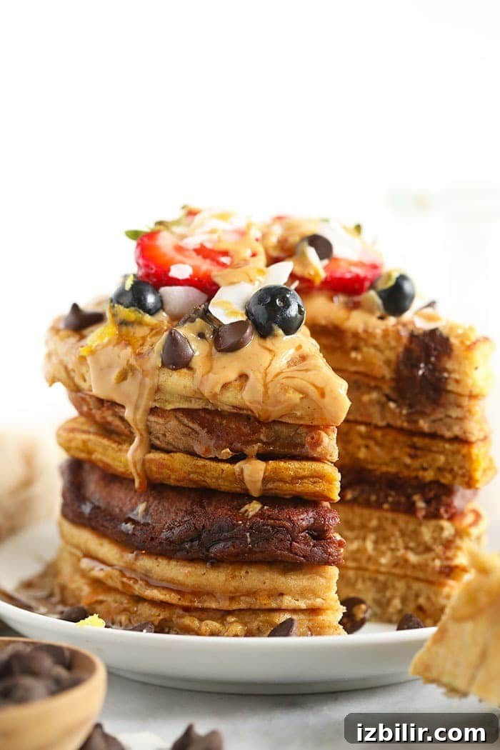 If you love pancakes, add this healthy pancake recipe to the list! This is our favorite pancake base recipe + 6 healthy pancake recipes you can make with it. Start flipping those flapjacks! a stack of pancakes with topings!