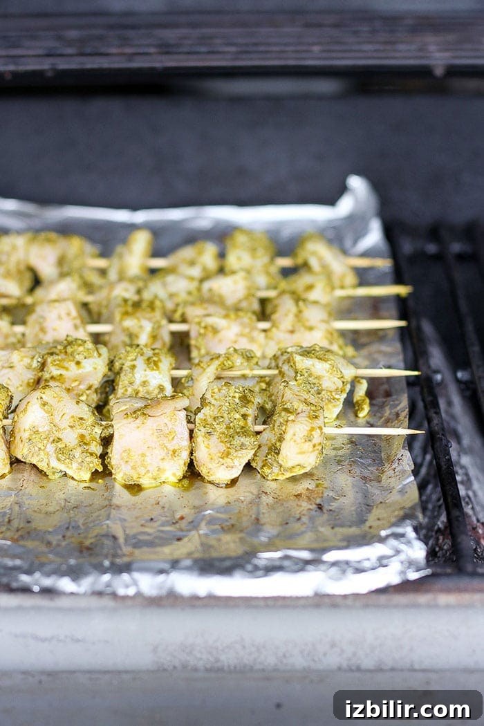 chicken skewers on a grill.